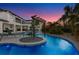 Gorgeous backyard pool featuring a unique lazy river design, lush landscaping, and a tanning deck at 1148 Grand Traverse Pkwy, Reunion, FL 34747