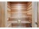 Relaxing home sauna features natural wood, built-in bench seating, and traditional sauna accessories at 1148 Grand Traverse Pkwy, Reunion, FL 34747