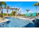 Luxury swimming pool with in-pool lounge chairs and tropical landscaping, perfect for relaxing by the water at 1148 Grand Traverse Pkwy, Reunion, FL 34747