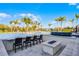 Backyard swimming pool area with bar seating, a fire pit, and tropical landscaping for outdoor enjoyment at 1148 Grand Traverse Pkwy, Reunion, FL 34747