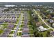 An aerial view shows this community with well-maintained lawns and sidewalks near a lake and lush vegetation at 1150 August Sky Dr, Deltona, FL 32738