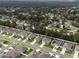 An aerial view of the houses in a neighborhood with well-maintained lawns and a tree-lined backdrop at 1150 August Sky Dr, Deltona, FL 32738