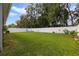 Large backyard features lush green grass surrounded by a white fence, offering privacy at 1150 August Sky Dr, Deltona, FL 32738