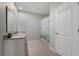 Bright bathroom featuring a white vanity with granite countertop and tiled floor at 1150 August Sky Dr, Deltona, FL 32738