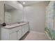 Bright bathroom featuring a white double vanity with granite countertop and tiled floor at 1150 August Sky Dr, Deltona, FL 32738