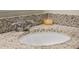 Granite countertop featuring a white sink and faucet with decor and granite backsplash at 1150 August Sky Dr, Deltona, FL 32738