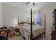 Cozy bedroom featuring a four-poster bed, ceiling fan and comfortable furnishings at 1150 August Sky Dr, Deltona, FL 32738