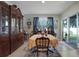 Dining room with a classic china cabinet, traditional table setting, and sliding glass doors to the backyard at 1150 August Sky Dr, Deltona, FL 32738