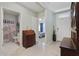 Inviting foyer with tile flooring, showcasing an antique desk, a hallway to the bedroom and a glimpse into the bathroom at 1150 August Sky Dr, Deltona, FL 32738