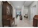 Hallway with tile flooring leading to bedrooms and living areas. A large wood cabinet on the left at 1150 August Sky Dr, Deltona, FL 32738