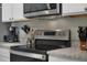 Modern kitchen featuring stainless steel appliances, granite countertops, and white cabinetry at 1150 August Sky Dr, Deltona, FL 32738