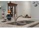Close-up of a granite kitchen countertop with a stainless steel sink and modern faucet at 1150 August Sky Dr, Deltona, FL 32738
