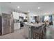 Bright kitchen with stainless steel appliances, granite counters, and an island with bar seating at 1150 August Sky Dr, Deltona, FL 32738