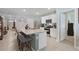 Open kitchen with stainless steel appliances, a granite island with seating, and lots of countertop space at 1150 August Sky Dr, Deltona, FL 32738