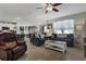Spacious living room with tile floors, comfortable seating, and open layout connecting to the kitchen at 1150 August Sky Dr, Deltona, FL 32738