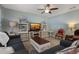 Cozy living room with a ceiling fan, decorative shelving, and comfortable seating at 1150 August Sky Dr, Deltona, FL 32738