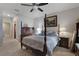 Comfortable bedroom featuring a four-poster bed, soft lighting, and carpeted floors at 1150 August Sky Dr, Deltona, FL 32738
