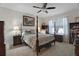 Cozy bedroom with a four-poster bed, soft lighting, and a view of the window at 1150 August Sky Dr, Deltona, FL 32738