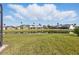 Expansive backyard view featuring a tranquil pond and neighboring screened lanais for outdoor enjoyment at 1207 Winding Cypress Ct, Kissimmee, FL 34746