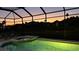Screened pool and spa with a stunning sunset view, ideal for relaxation and entertaining at 1207 Winding Cypress Ct, Kissimmee, FL 34746