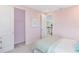 Cute pink bedroom with large wardrobe and view of upstairs hallway at 1224 Teal Creek Dr, St Cloud, FL 34771
