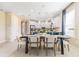 Bright dining room with modern table and chairs, plus open view to the kitchen at 1224 Teal Creek Dr, St Cloud, FL 34771
