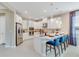 Modern kitchen with white cabinets, stainless steel appliances, and an island with barstool seating at 1224 Teal Creek Dr, St Cloud, FL 34771