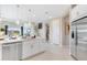 Modern kitchen showcasing white cabinetry, stainless steel appliances, and a seamless open-concept design at 1224 Teal Creek Dr, St Cloud, FL 34771