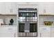 Built-in stainless steel appliances in a modern kitchen with stylish white cabinets at 1224 Teal Creek Dr, St Cloud, FL 34771