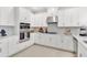 Kitchen with stainless steel appliances, white cabinets, and a modern range hood and backsplash at 1224 Teal Creek Dr, St Cloud, FL 34771