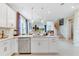 Bright kitchen with island, stainless steel appliances, white cabinets, and an open layout leading to the living space at 1224 Teal Creek Dr, St Cloud, FL 34771