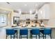 Open kitchen with white cabinetry, stainless steel appliances, and seating at the center island at 1224 Teal Creek Dr, St Cloud, FL 34771