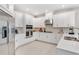 Bright kitchen featuring white cabinetry, stainless steel appliances, and stylish backsplash at 1224 Teal Creek Dr, St Cloud, FL 34771