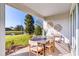 Inviting covered lanai features a modern dining table, decor and serene views of lush landscaping and pond at 1224 Teal Creek Dr, St Cloud, FL 34771