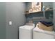 Functional laundry area featuring modern machines, ample storage, and a clean, organized design at 1224 Teal Creek Dr, St Cloud, FL 34771