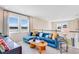 Cozy living room featuring a comfortable blue sectional sofa and modern decor with views of the scenery at 1224 Teal Creek Dr, St Cloud, FL 34771