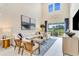 Spacious living room with tall ceilings, large windows, and stylish decor at 1224 Teal Creek Dr, St Cloud, FL 34771