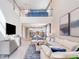 Open-concept living room featuring tall ceilings, modern furniture, and seamless flow into the kitchen at 1224 Teal Creek Dr, St Cloud, FL 34771