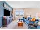 Inviting living room with a blue sectional sofa, modern TV, and natural light from the double windows at 1224 Teal Creek Dr, St Cloud, FL 34771