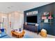 Modern living room with a large TV, blue accent wall, and comfortable seating for relaxation and entertainment at 1224 Teal Creek Dr, St Cloud, FL 34771