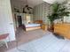 Spacious bedroom features an open layout with leaf-patterned wallpaper and natural lighting at 123 Breezy Oaks Ct, Davenport, FL 33896