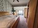 Spacious bedroom features an open layout with patterned wallpaper, closet, and natural lighting at 123 Breezy Oaks Ct, Davenport, FL 33896