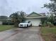 Charming one story home with a two car garage and an inviting driveway and front yard at 123 Breezy Oaks Ct, Davenport, FL 33896