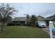 Inviting one-story home with a well-maintained lawn and mature landscaping at 123 Breezy Oaks Ct, Davenport, FL 33896