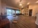 This expansive living room features wood floors, and sliding glass doors to the lanai at 123 Breezy Oaks Ct, Davenport, FL 33896