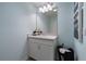 Cozy powder bathroom with a large vanity, mirror, and modern lighting at 1234 Sand Torch Cir, Davenport, FL 33837