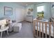Light and airy Bedroom with a crib, chair, and outdoor view at 1234 Sand Torch Cir, Davenport, FL 33837