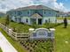 An aerial view of Legacy Landing community entrance with lush landscaping and blue siding at 1234 Sand Torch Cir, Davenport, FL 33837