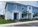 Charming two-story townhome featuring a blue exterior with well manicured landscaping at 1234 Sand Torch Cir, Davenport, FL 33837