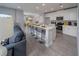 Bright, eat-in kitchen featuring white cabinets and island with barstool seating at 1234 Sand Torch Cir, Davenport, FL 33837